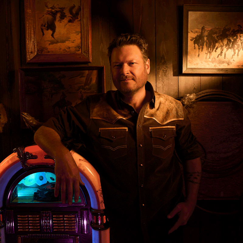 Cover art from Blake Shelton's album, For Recreational Use Only. In an old honky-tonk, with cowboy paintings on the walls, Blake sits in front of a retro jukebox.